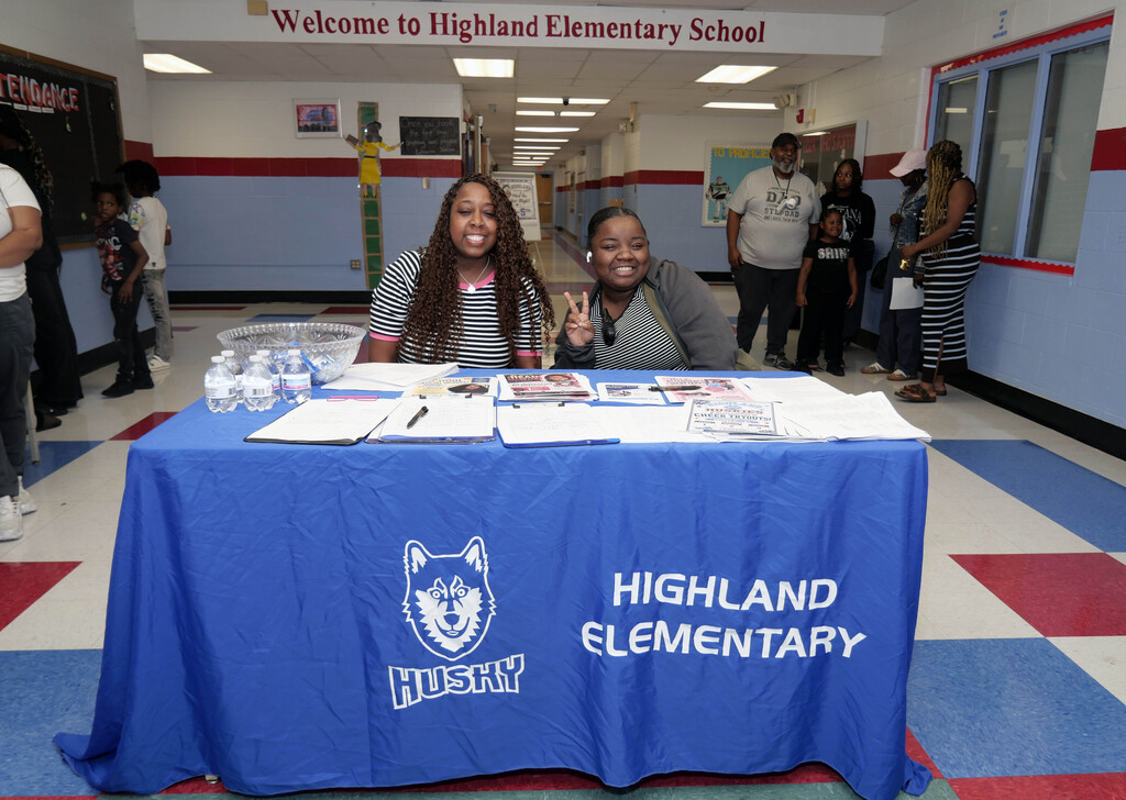 Staff members posing at table at Highland Elementary