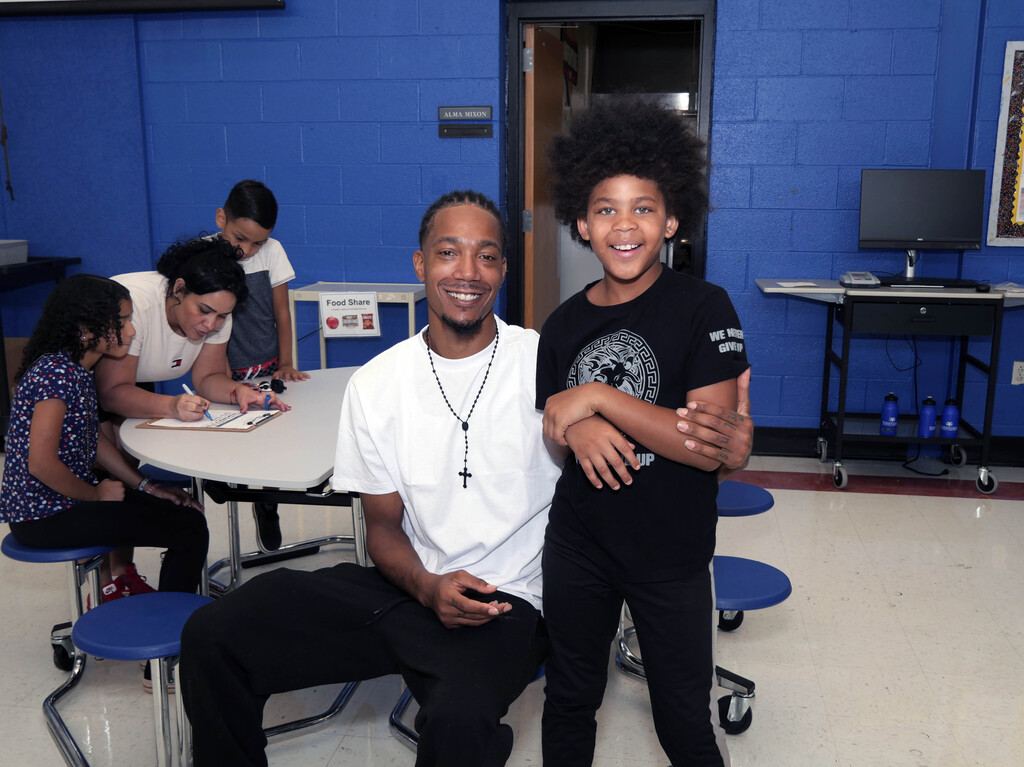 Male elementary student and parent pose
