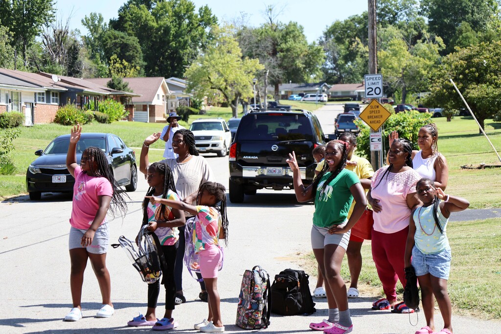 Parade goers wave, smile and wait for candy