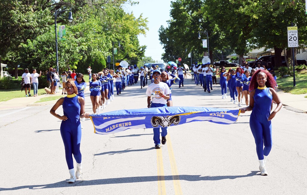 The Sensational Sapphires lead the RGHS Mighty Marching Golden Rams marching band in a parade.