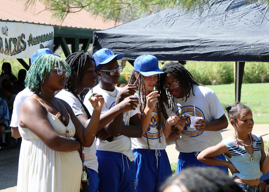 Riverview Gardens High School students look at their raffle tickets during the announcement of winners