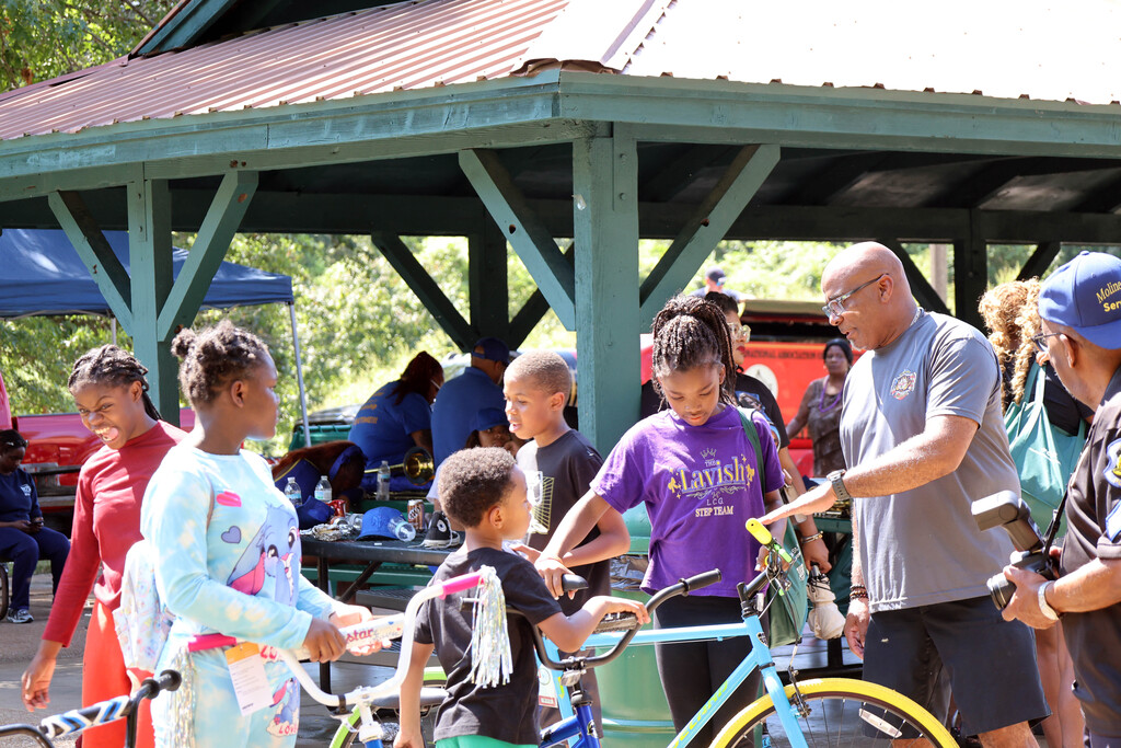 Kids receive free bikes during the Moline Acres Awareness Day Parade