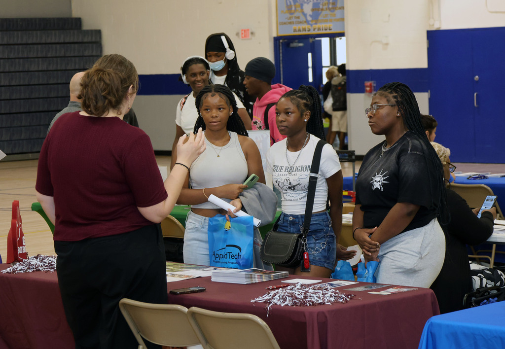 Students talk to college recruiter