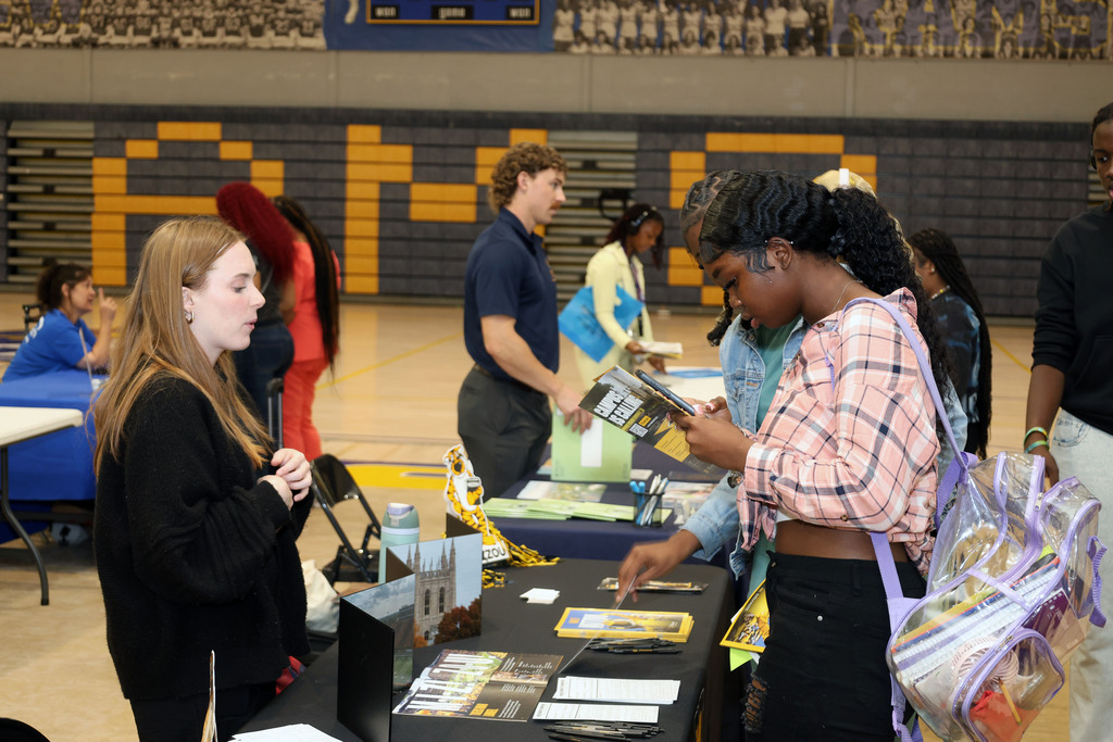 Students talk to college recruiter