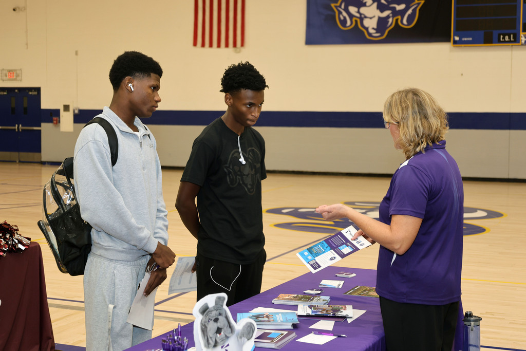 Students talk to college recruiter