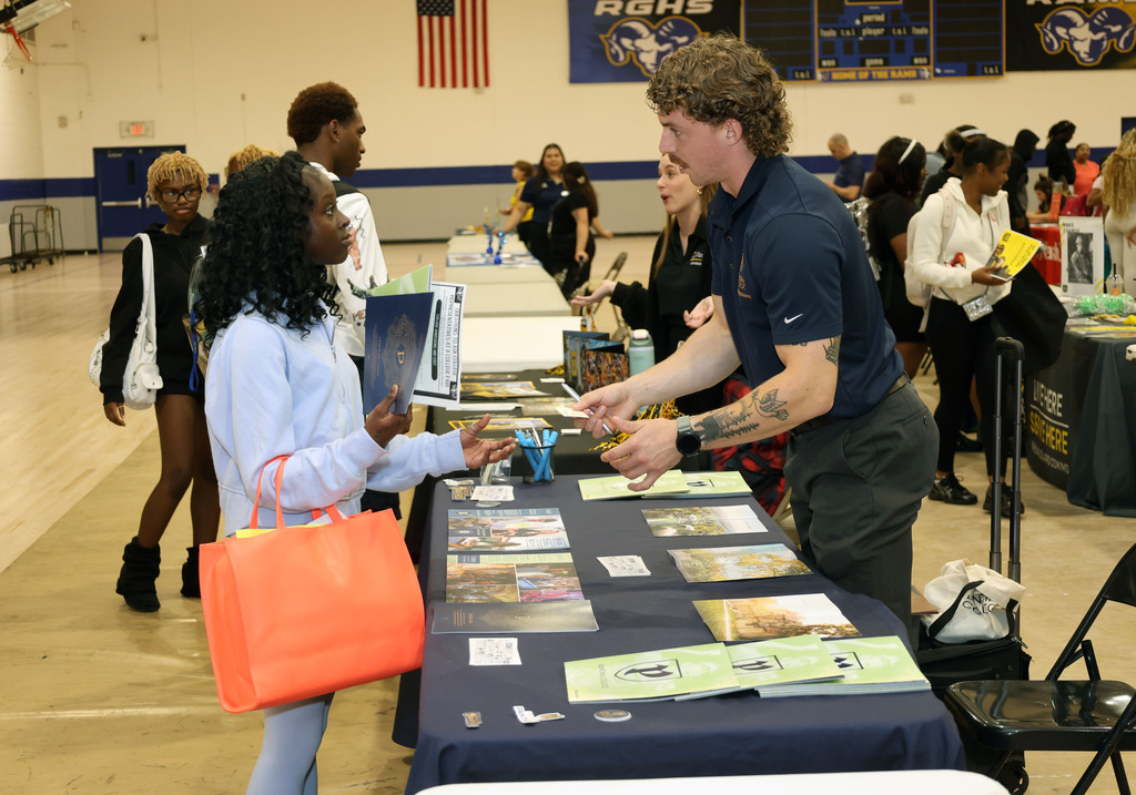 Students talk to college recruiter