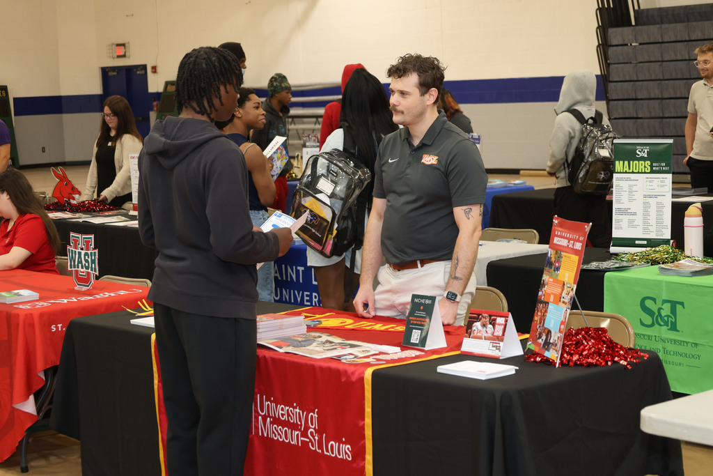 Students talk to college recruiter