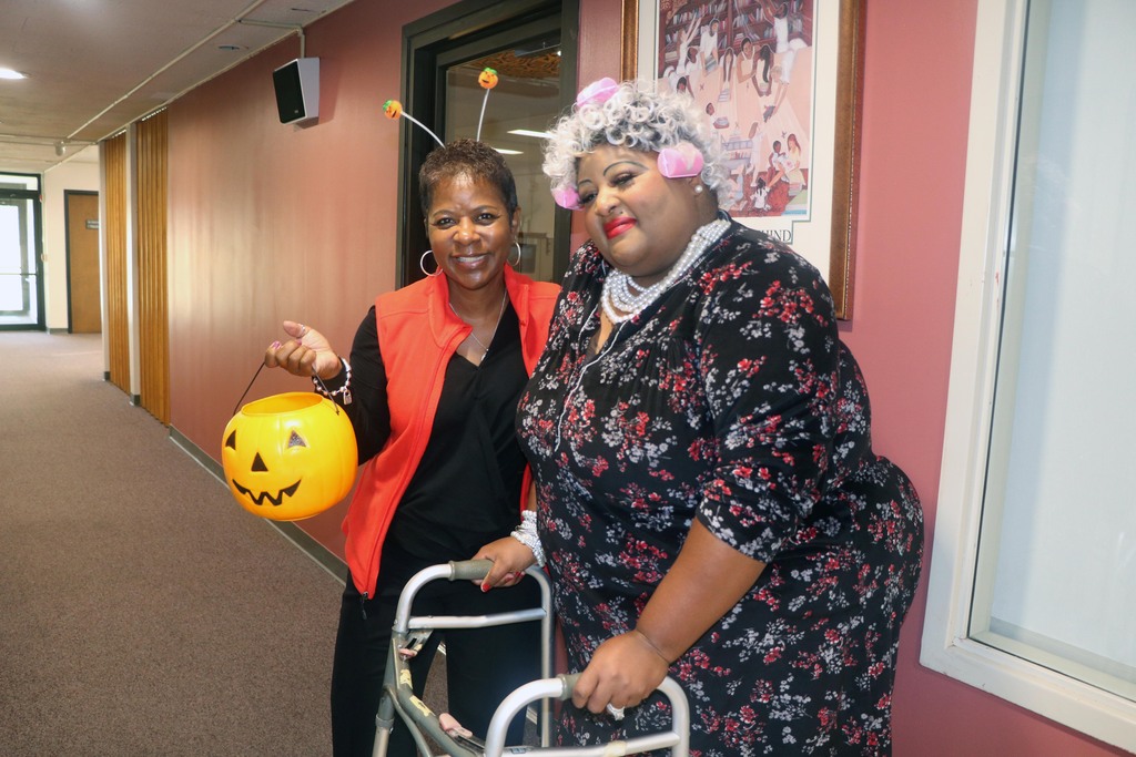 Dr. Tanya Patton poses with employee in Halloween costumes
