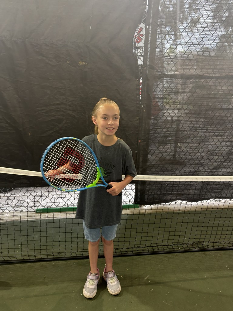 Student holding a tennis racket. 