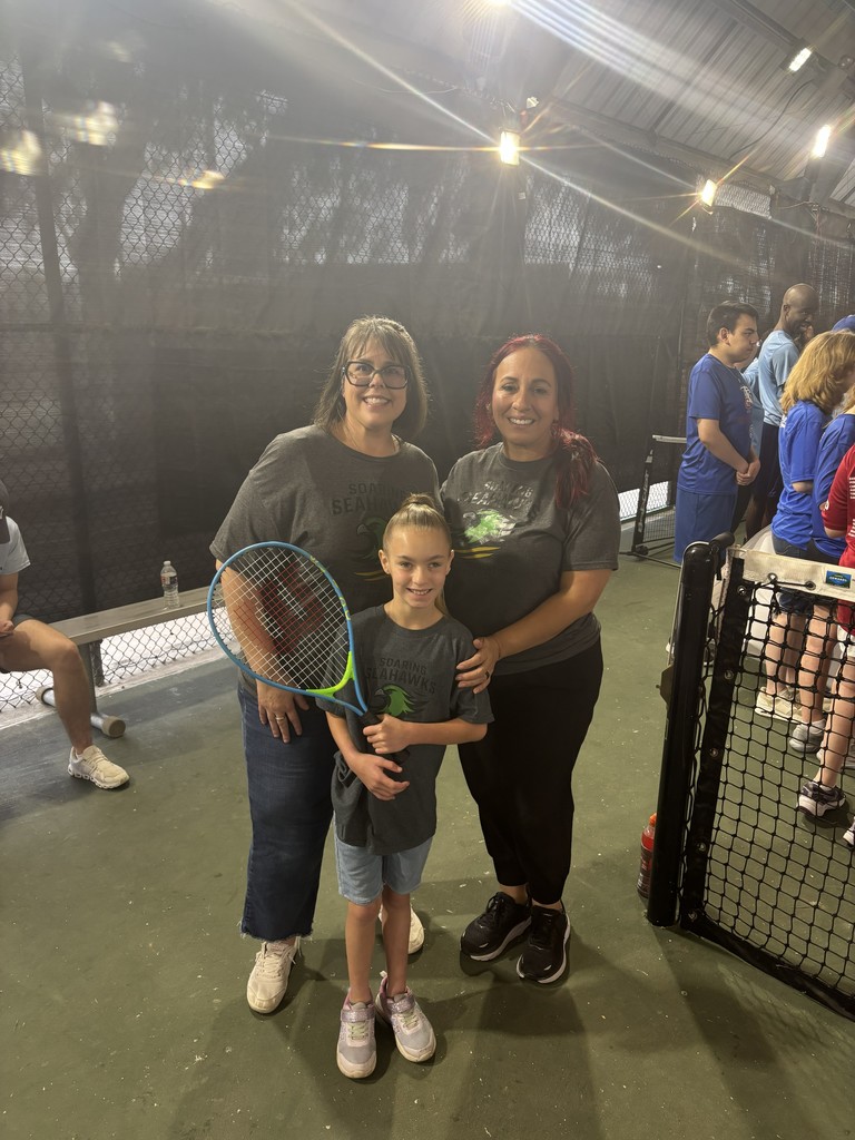 Student standing with teachers. 