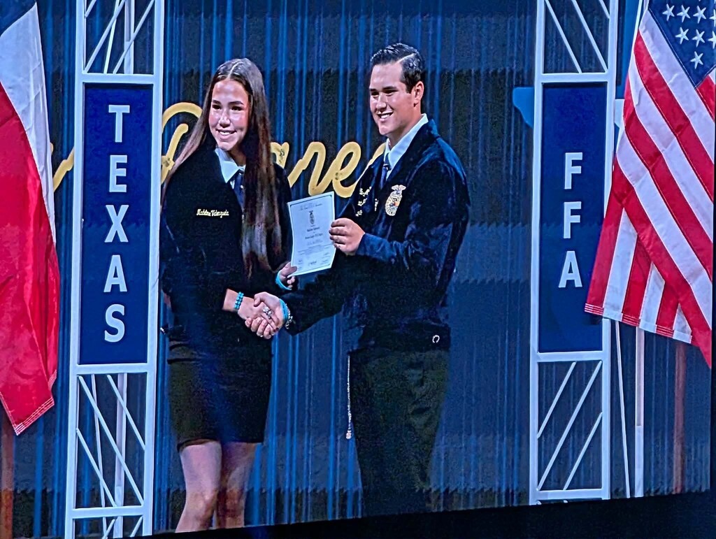 Maddie receiving her award