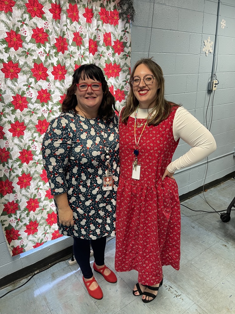 Mrs. Ann and Mrs. Welch wearing Christmas dresses.