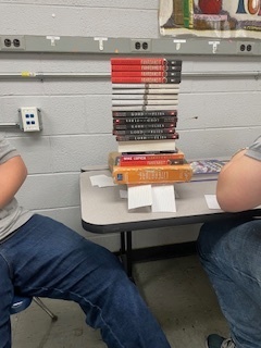 Books stacked on index card structure