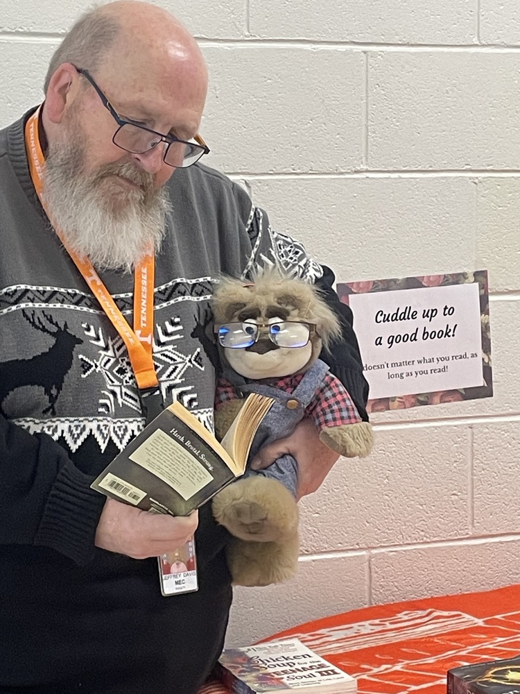The theme for the MEC Achieve table for January is "Cuddle Up to a Good Book.".   Mr Davis and his friend, Bubba, are doing just that. It doesn't matter what you read, as long as you read. 