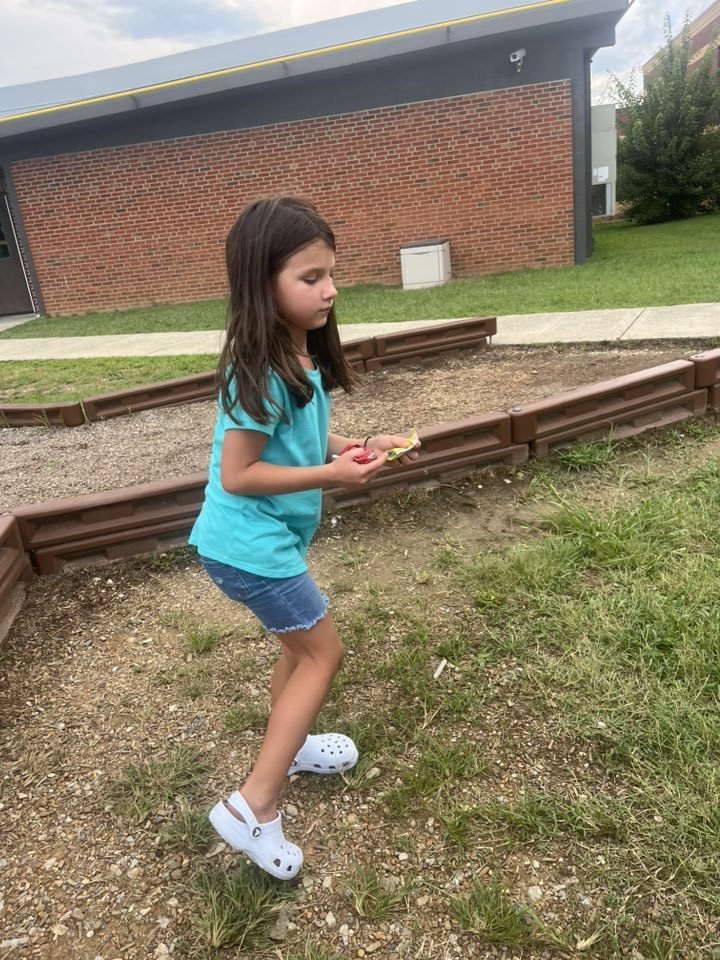 student picking up trash