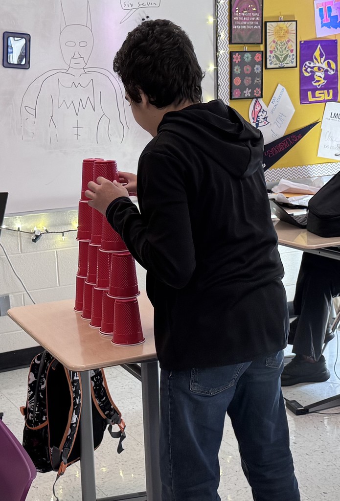 student in stacking contest with cups