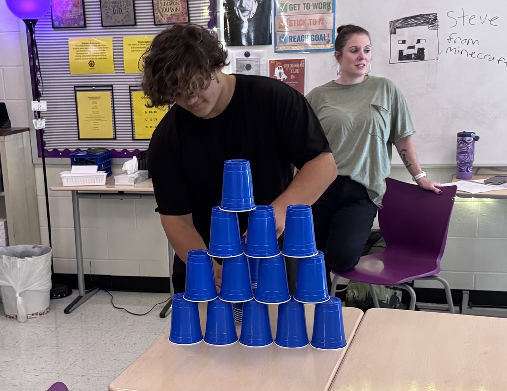 student in stacking contest with cups