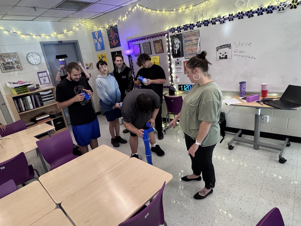 student in stacking contest with cups