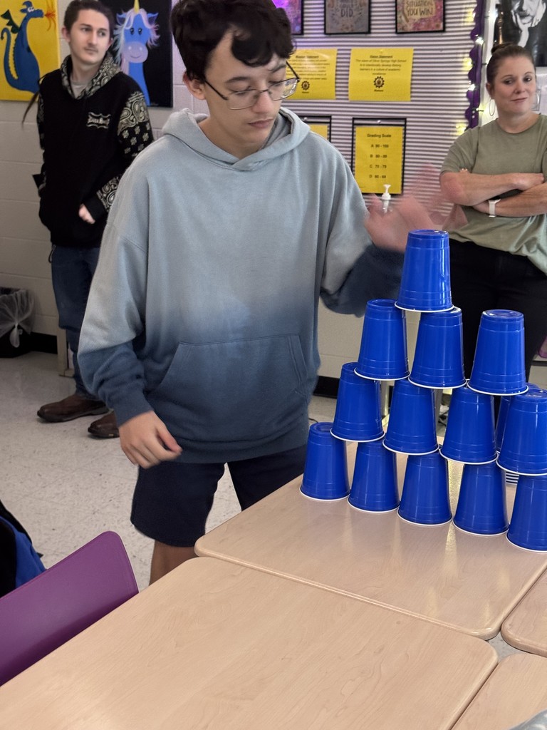 student in stacking contest with cups