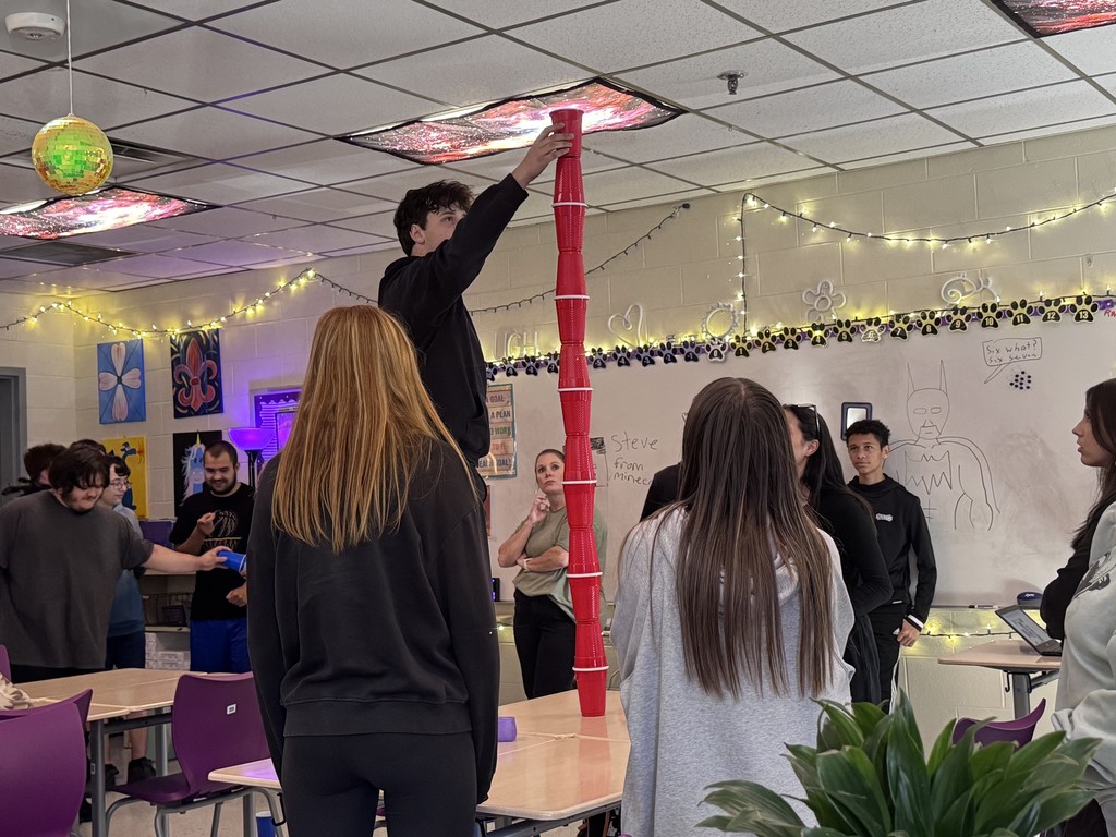 student in stacking contest with cups