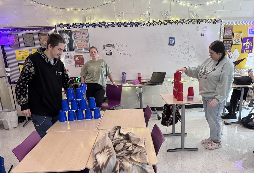 student in stacking contest with cups