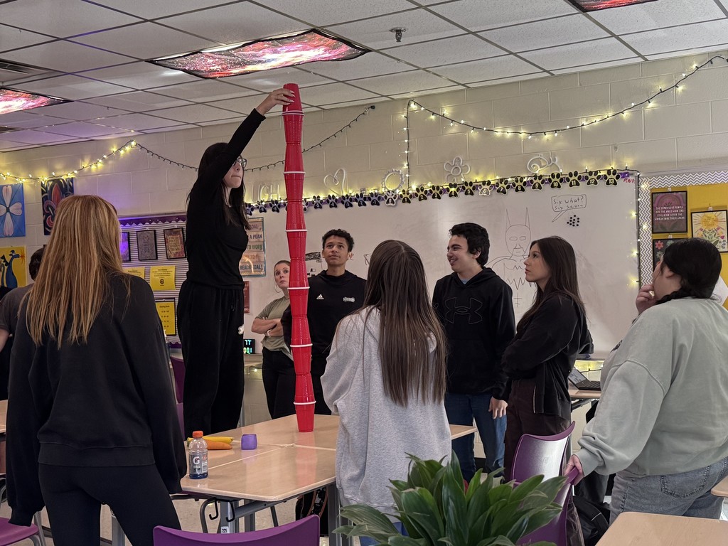 student in stacking contest with cups