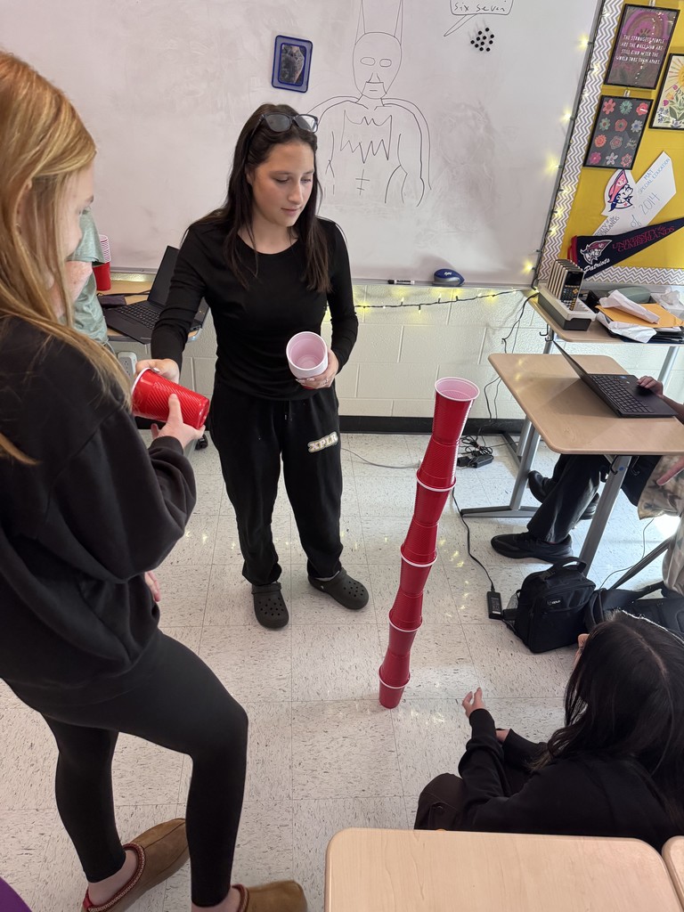 student in stacking contest with cups