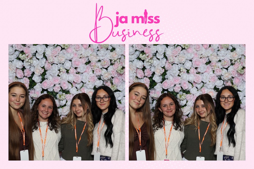 photo booth photo of the 4 girls in front of a wall of flowers