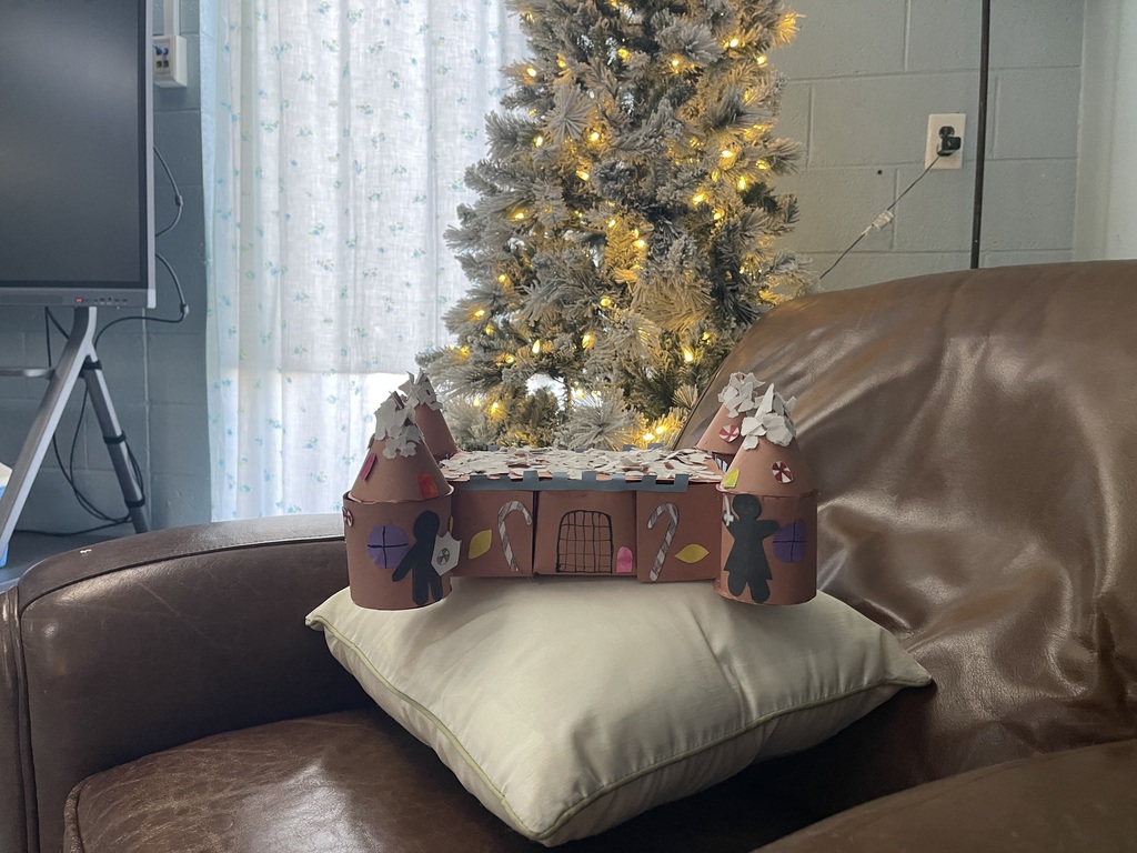 House with towers and turrets, gingerbread man/woman cut out, and candy canes.
