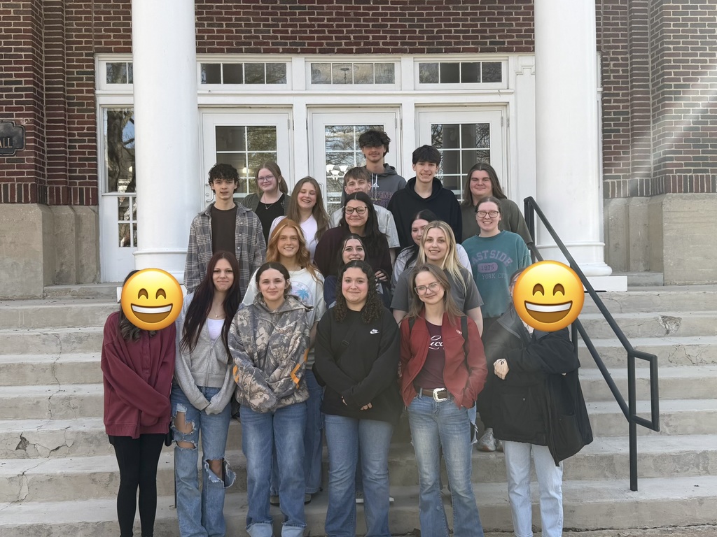 group photo of students on the trip on the front steps of college