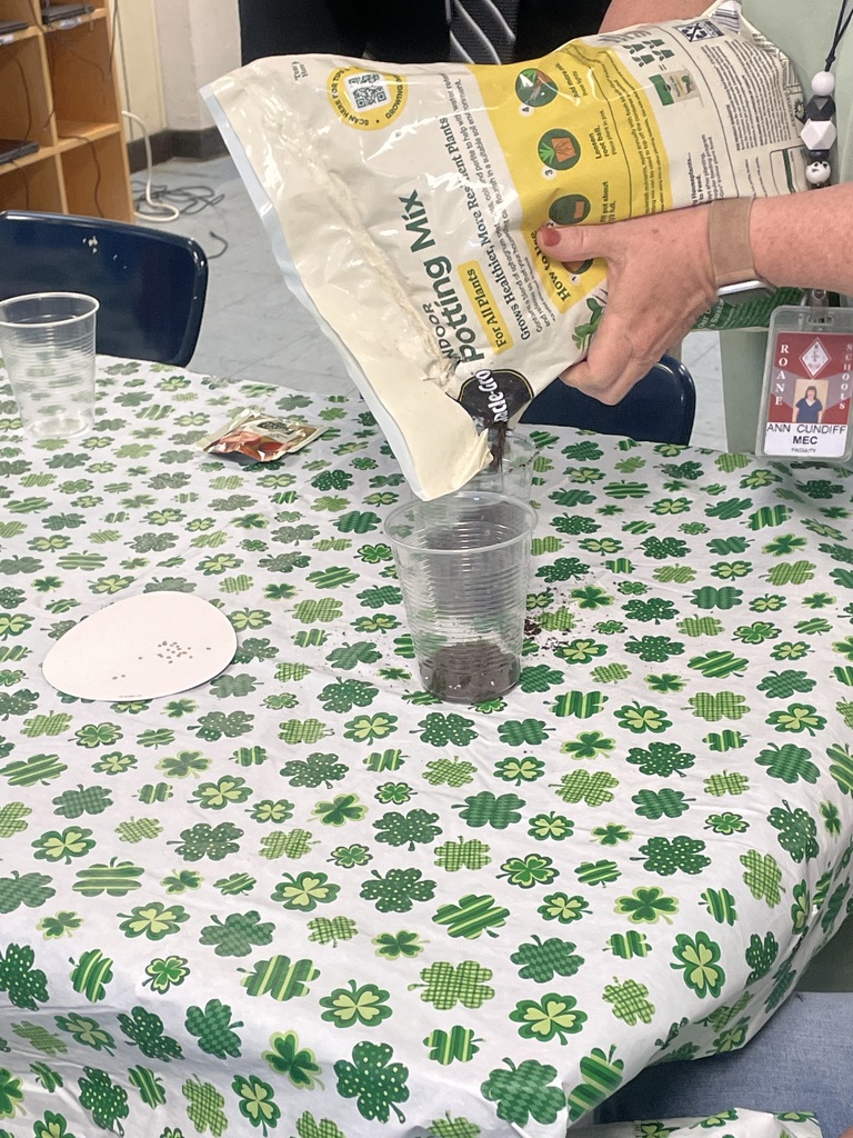 Pouring dirt into a cup