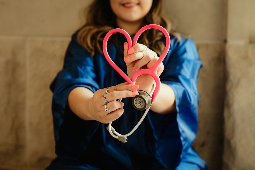 Stethoscope in shape of heart held by nurse.
