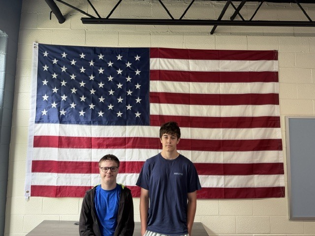 Jessie and Bear posing in front of American flag