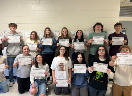 students holding their certificates