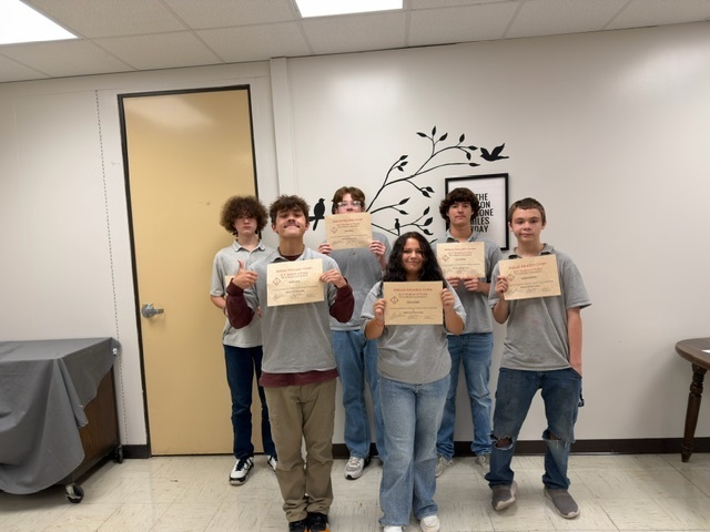 Students holding certificates