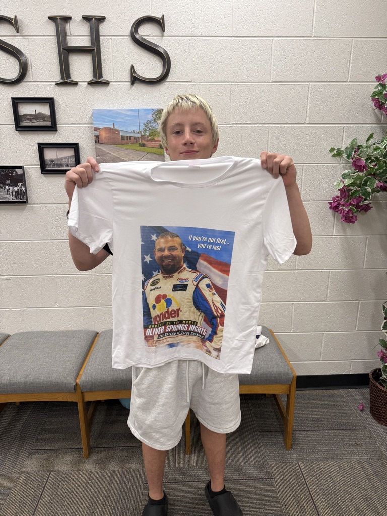 Quinton holding the Bobcat of the Month tee