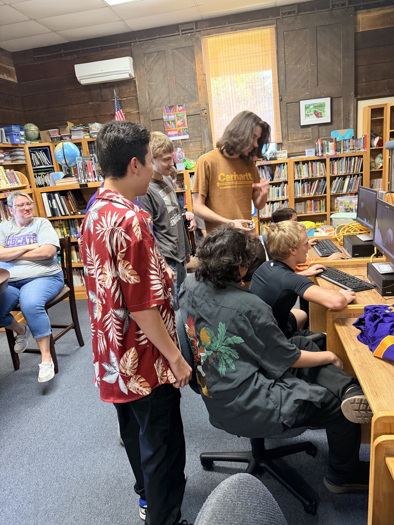 students in library looking at computer