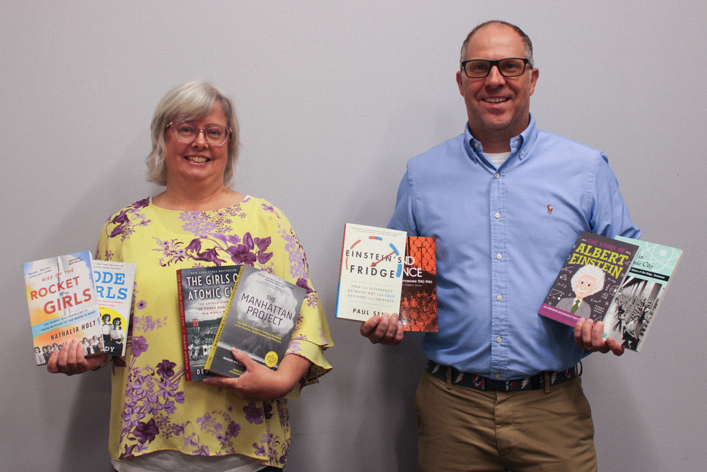 Mrs. Robbins and Kairos employee holding books