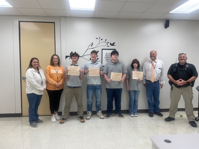 Students holding certificates with principal, SRO, guidance counselor, and GAP assistant.