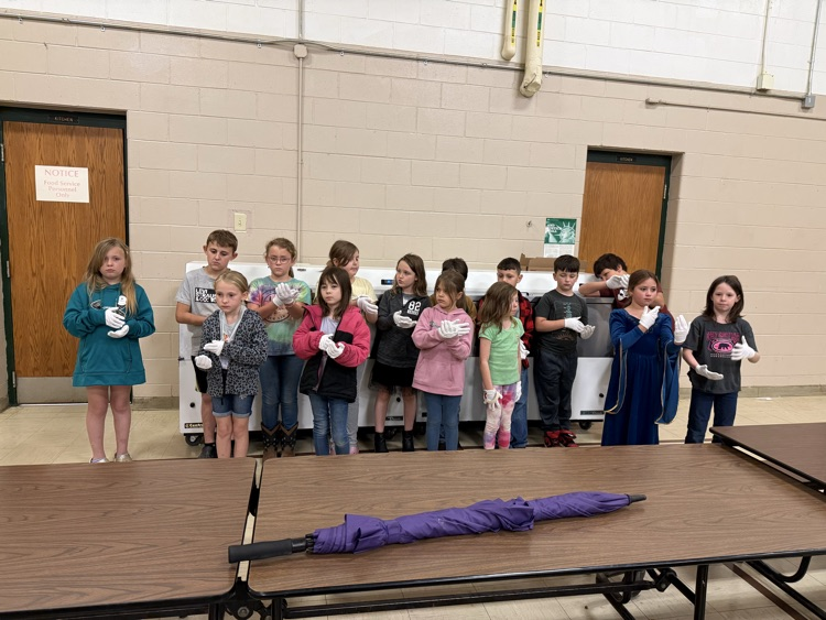 2nd grade students in 2 rows with white gloves