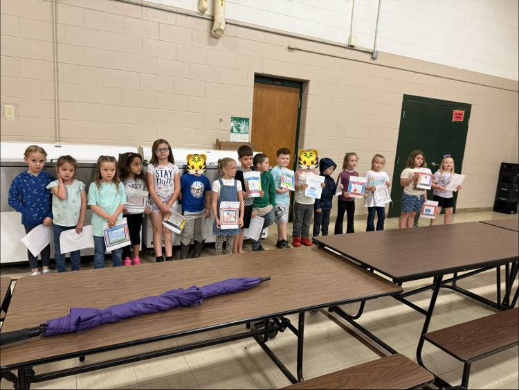 kindergarten students holding papers