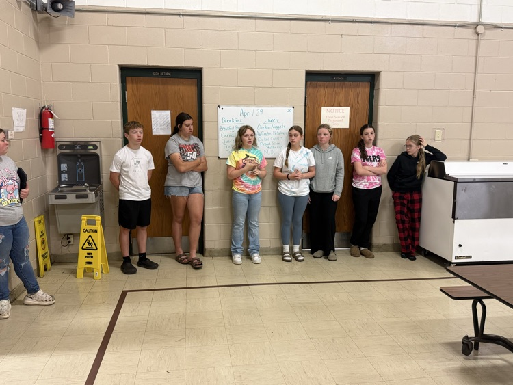 middle school students leaning by the wall