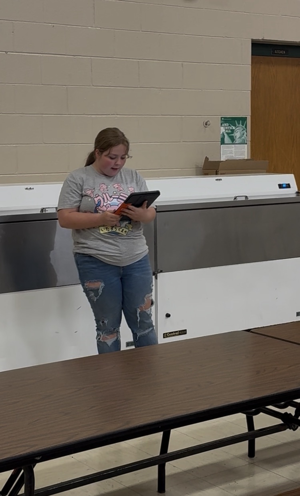 middle school student reading story from iPad