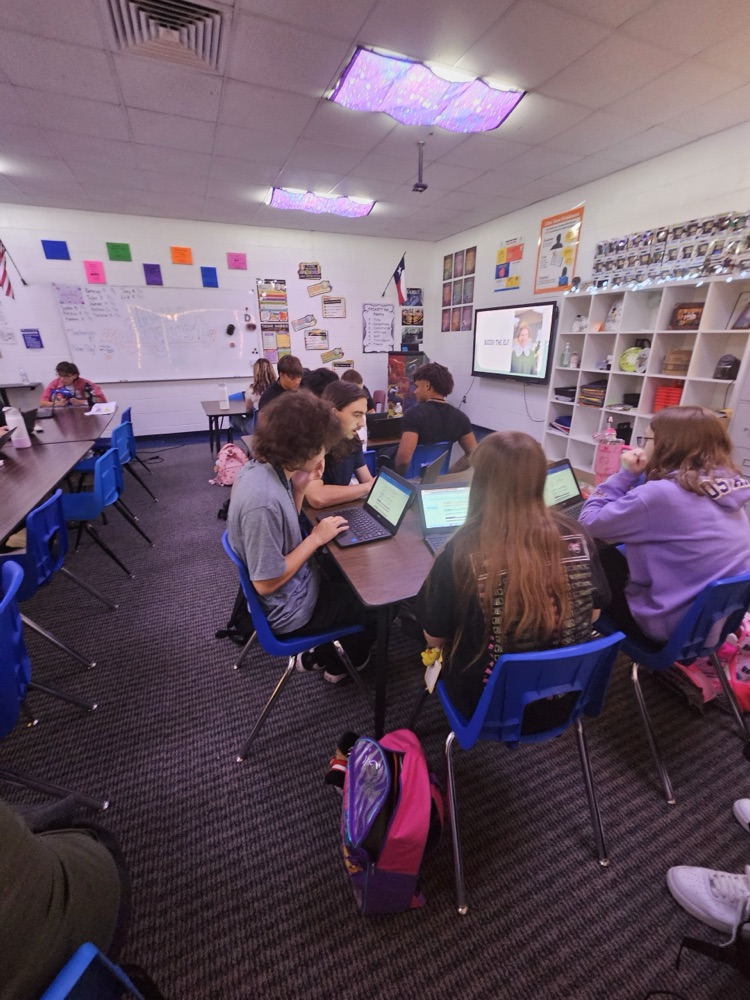 English students working hard analyzing various texts.