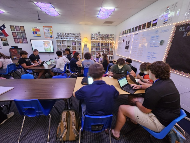 English students working hard analyzing various texts.