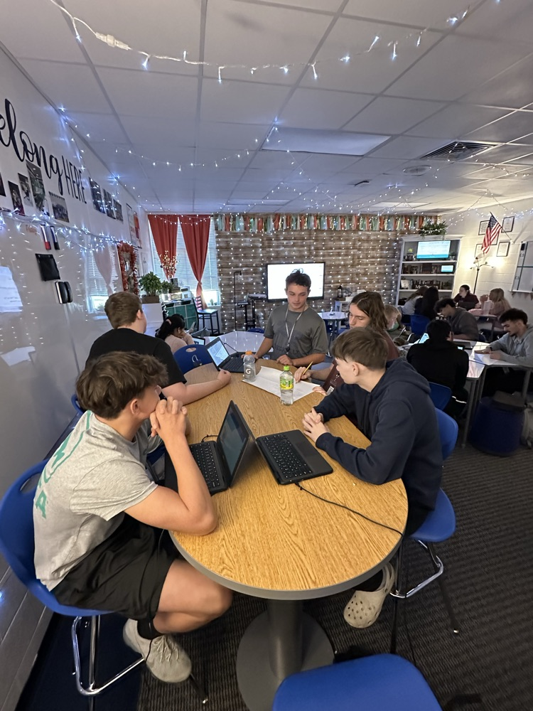 English students working hard analyzing various texts.