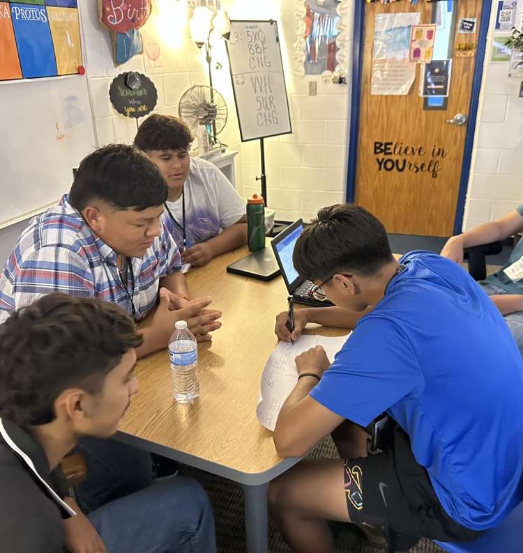 English students working hard analyzing various texts.