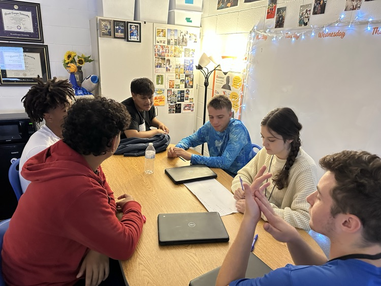 English students working hard analyzing various texts.