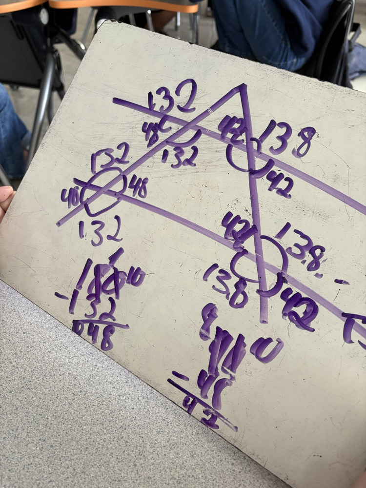 whiteboard with lines and angles drawn on it