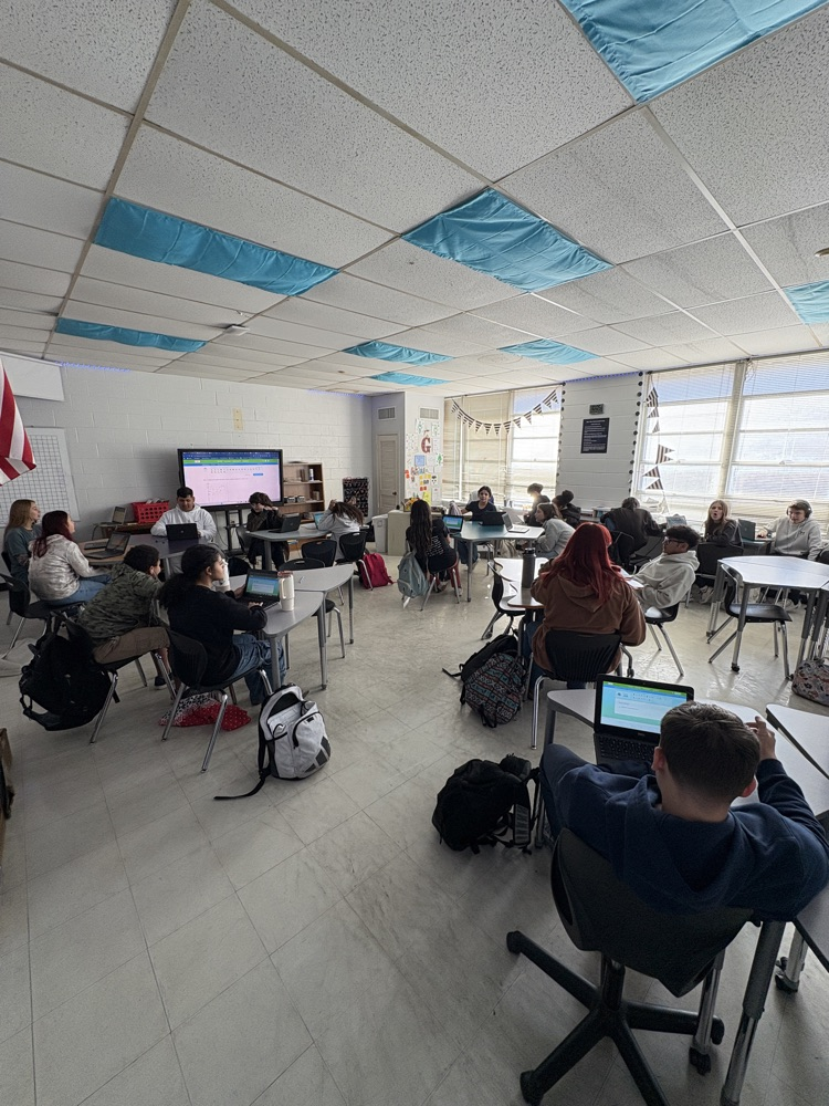 students in a classroom with chromebooks